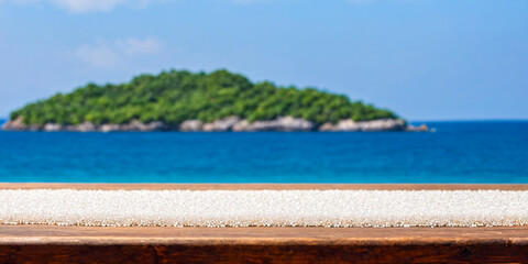 Fototapeta premium Wooden Table with White Beads and Ocean View.