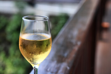 a glass of white wine served in a restaurant, abstract background of a summer restaurant