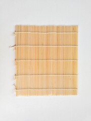 Makisu, sushi rolling bamboo mat on white background.