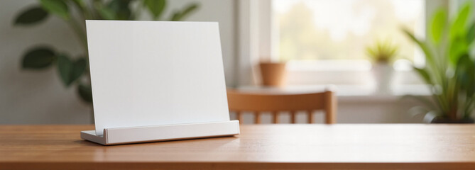 Flyer mockup with holder on wooden table in bright room