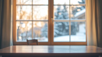 Fototapeta premium A wooden table in front of a window showing a winter scene, bokeh effect