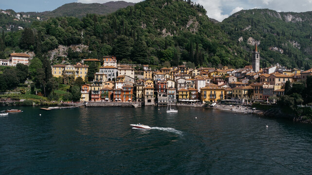 Aerial view of boat trip near Bellano, panoramic view from the drone to the famous old Italy town of Como lake. Near Varenna and Lierna, Bellano is a small town in Como, near Lecco, in Lombardia.