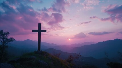 Holy concept: A silhouette of the cross on top of the hill with an on-mountain sunset beautiful sky background, the concept for Easter and Jesus Christ.