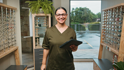 Optometrist Business Professional in Optical Store Holding Tablet