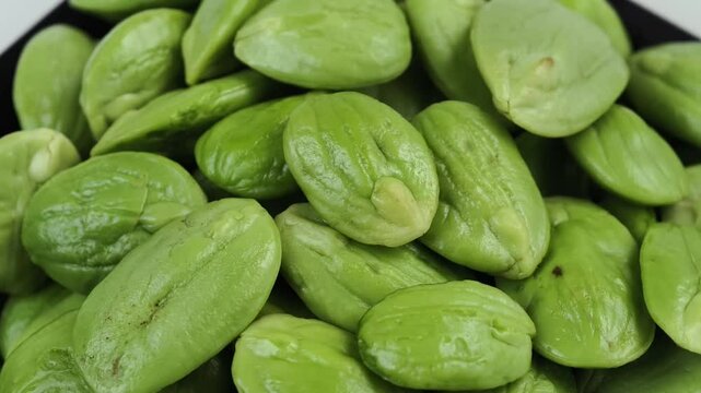 Fresh stink beans rotating on a plate