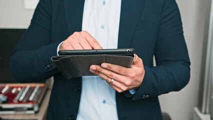 Professional Man Using a Digital Tablet in a Modern Business Environment
