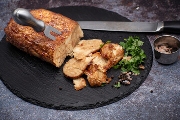 Seitan: vegan meat alternative made with vital wheat gluten, sliced on slate board