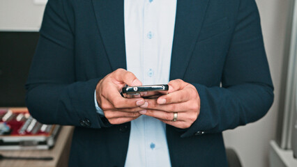 Business Professional Communicating Using a Smartphone in an Office Environment