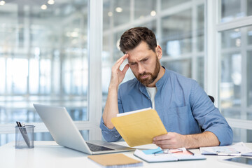 Bad news mail message about bankruptcy. Man upset inside office disappointed reading notification,...