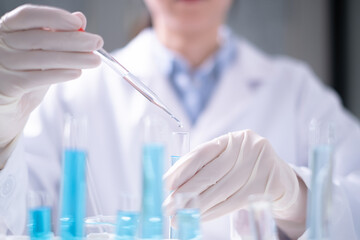 Fototapeta premium Close-up scientist pipette drop to test tube laboratory research chemistry chemical science research