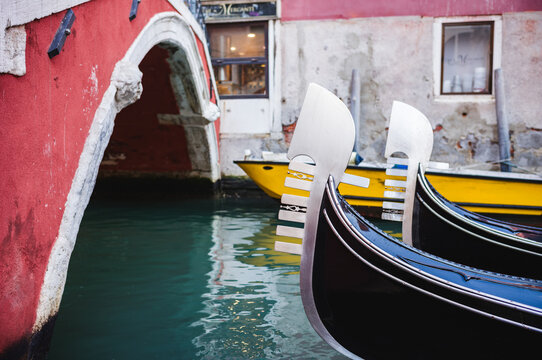 Gondolas prows and canal, Venice, Veneto, Italy