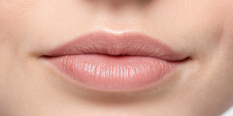 Obraz premium Close-up of Lips with Light Pink Lipstick