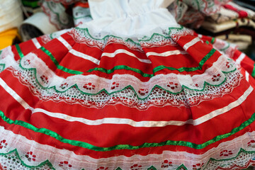 Traditional Mexican costume dress with red, green and white colors in street market