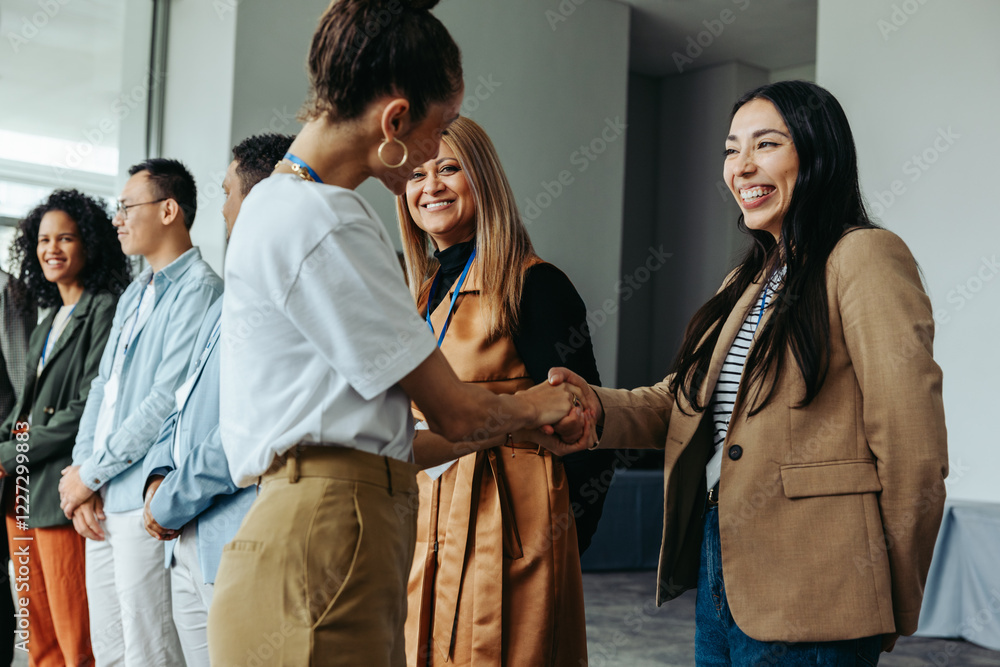 Wall mural diverse group of professionals networking and shaking hands at a business meeting