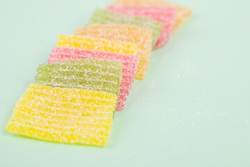 Colorful jelly candies on a green background, shallow dof
