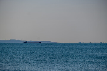 View of a ship at sea on the horizon.