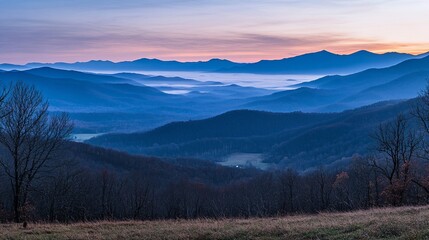 Majestic mountain ranges with layered blue ridges and a misty atmosphere, capturing the serene beauty of towering peaks and natural landscapes in the early morning light