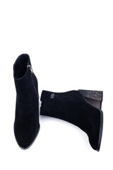 Black women's leather ankle boots with high heels made of leather, isolated on white background. Women's fashionable classic spring-autumn boots.