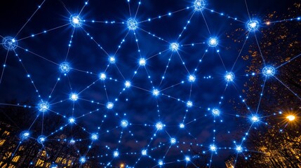 Fototapeta premium Blue Lights Connected by Lines Form an Abstract Network Pattern Against a Dark Night Sky.