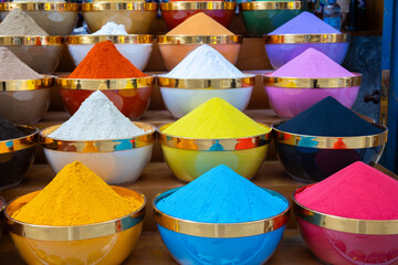 Traditional spices market. Pots and wooden tubs stand in row with colorful tea, spices, fruits, roots, flowers. Street bazaar.