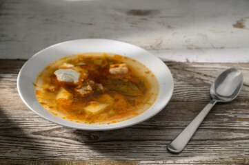 Warm soup bursting with flavors served in a rustic bowl on a wooden table