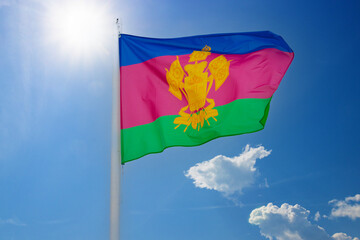 Flag of Krasnodar Krai against blue sky background. The Krasnodar Krai flag waving in the wind, Russia
