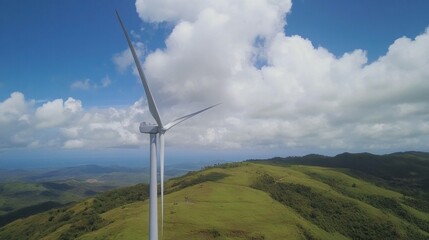Wind turbine on a green hill under a bright blue sky with fluffy white clouds, symbolizing renewable energy and environmental sustainability