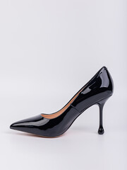 Black women's leather high-heeled pumps made of leather, isolated on a white background. Women's fashionable classic shoes