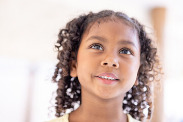 African American girl outdoors close-up child pretty smiling looking at camera ethnic schoolgirl standing in park portrait cute small baby pupil kid daughter face in city headshot custody.