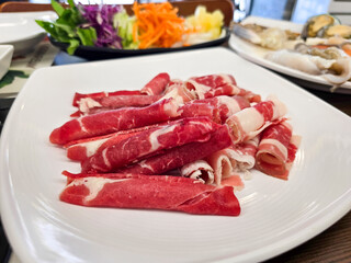 Shabu Shabu. Thinly sliced ​​beef on a plate