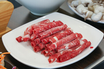 Shabu Shabu. Thinly sliced ​​beef on a plate
