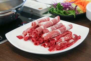 Shabu Shabu. Thinly sliced ​​beef on a plate
