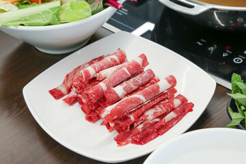 Shabu Shabu. Thinly sliced ​​beef on a plate