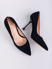 Black women's leather high-heeled pumps made of leather, isolated on a white background. Women's fashionable classic shoes