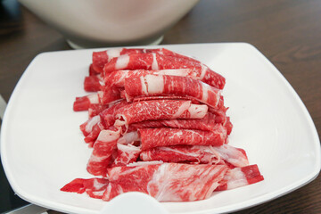 Shabu Shabu. Thinly sliced ​​beef on a plate