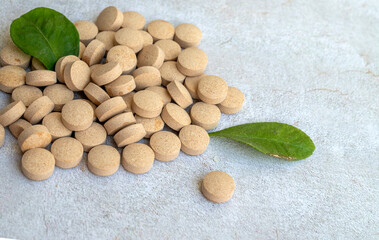 Herbal Supplements and green leaves . Herbal Remedies  Tablets  