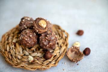 Chocolate candy with hazelnuts on shadows  background