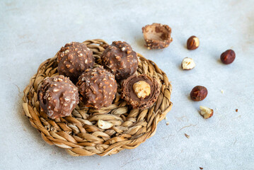Chocolate candy with hazelnuts on shadows  background