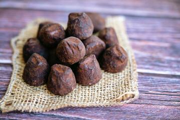 Chocolate truffles on wooden background