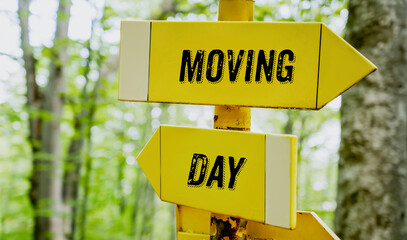 Moving day text on yellow arrows in the summer forest 