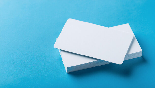 White empty business card on light blue background. Blank template for your design. Mock-up.