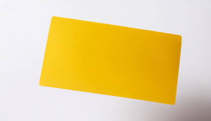 Yellow empty business card flying in the air, white background. Blank template for your design.