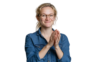 Smiling woman in denim shirt clapping hands.