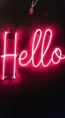 Neon hello sign glowing in bright pink light