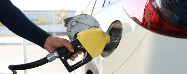 Man Refill and filling Oil Gas Fuel at station. Gas station - refueling.