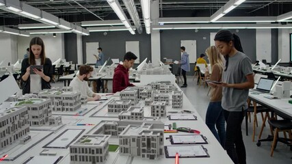 Students collaborate on architectural models in a design studio