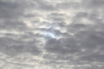 The sun breaks through the winter gray clouds