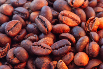 A heap of coffee beans stacked together, ready to be brewed into a delicious cup of coffee. Coffee beans isolated on white background