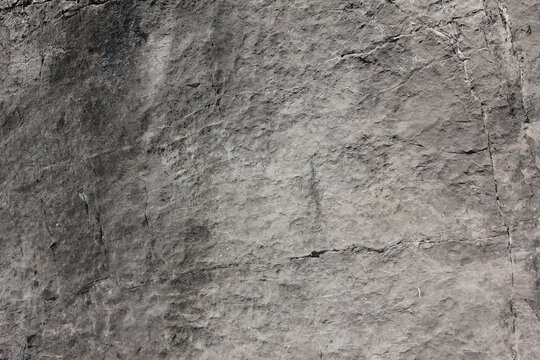 uneven grey rock face of slate mineral