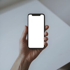 Photo of a hand holding a mobile phone. Plain white color is displayed on the smartphone.